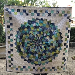 Hand-made baby quilt in blues and greens
